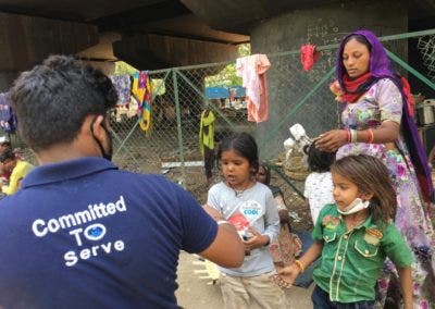 Volunteers distributing food to people in need