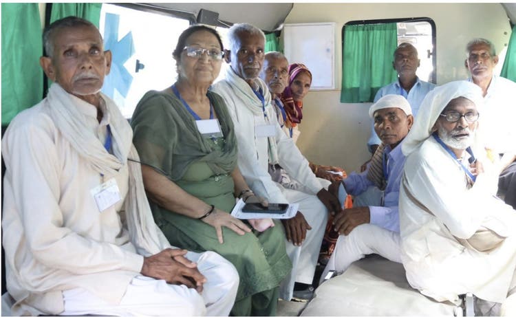 Volunteer doctors and medical staff with patients at the eye camp